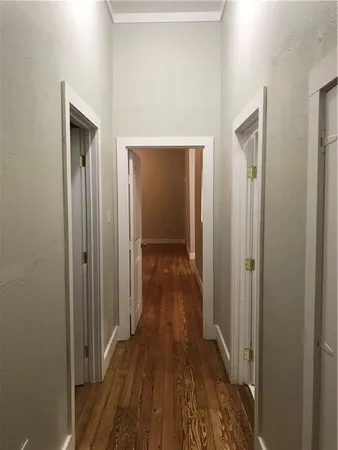 a view of a hallway with wooden floor