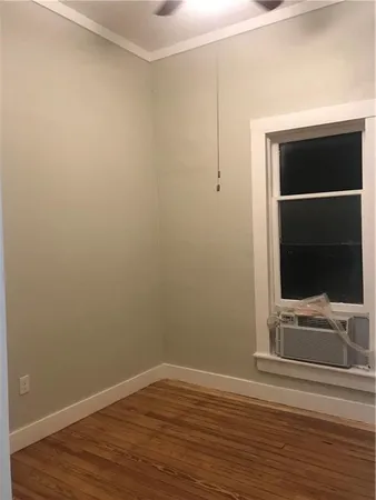 a view of room with wooden floor and flat screen tv