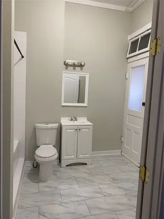 a bathroom with a toilet sink and a mirror