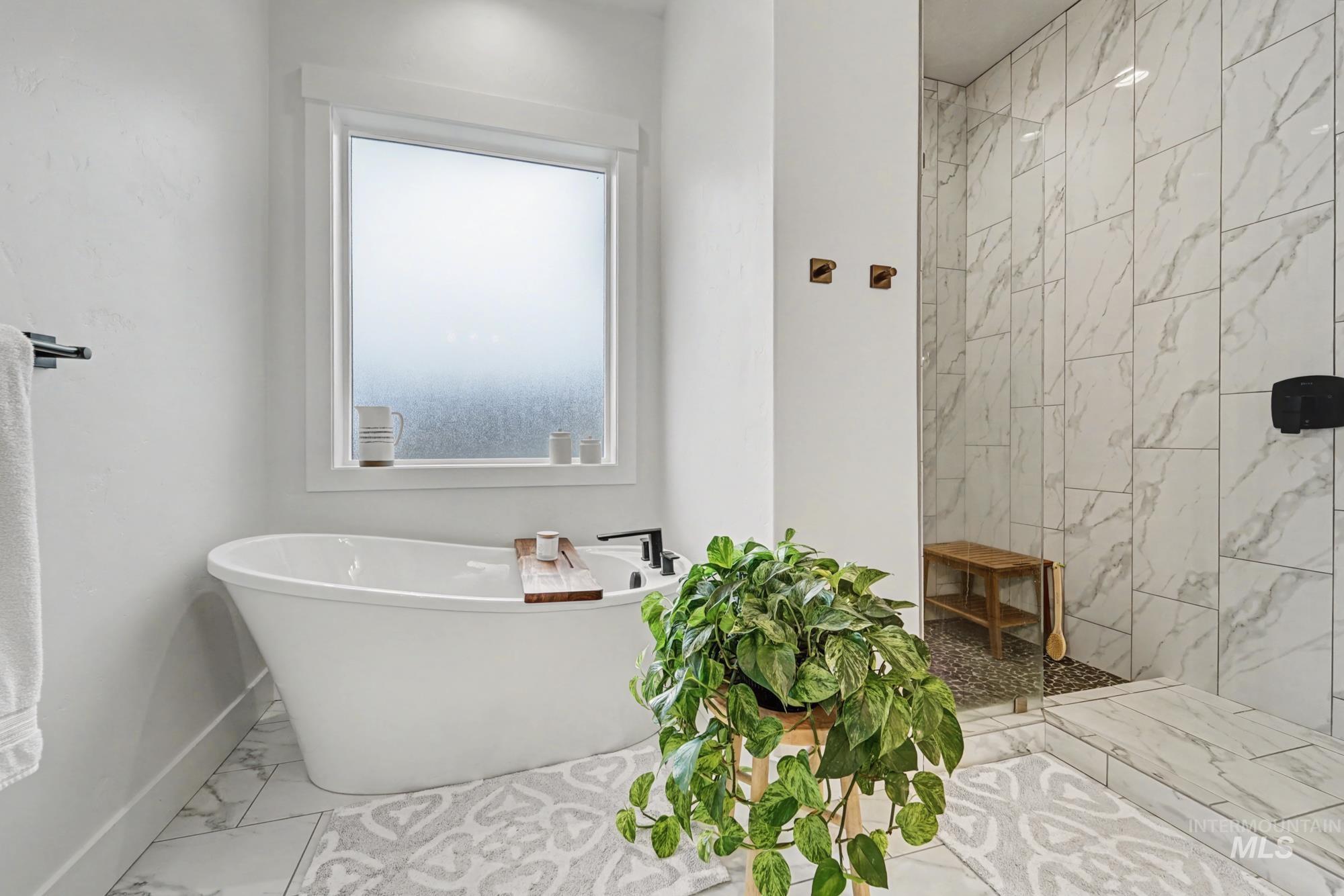 18357 North Burnt Car Way Boise, ID 83714 - Photo 24 of 48 Full bath featuring marble look tiles, a tile shower, and a freestanding bath