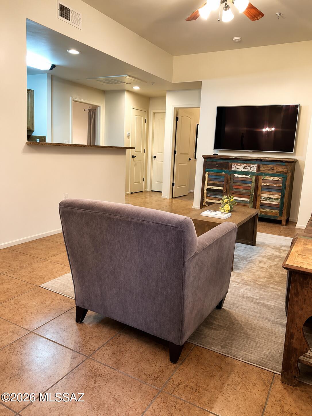 2018 East River Road, Unit 102 Tucson, AZ 85718 - Photo 8 of 25 a living room with furniture and a flat screen tv