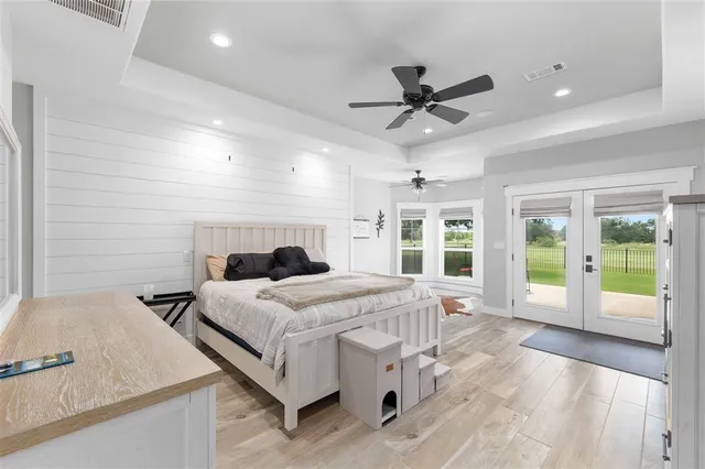 a bed room with a bed and a large window