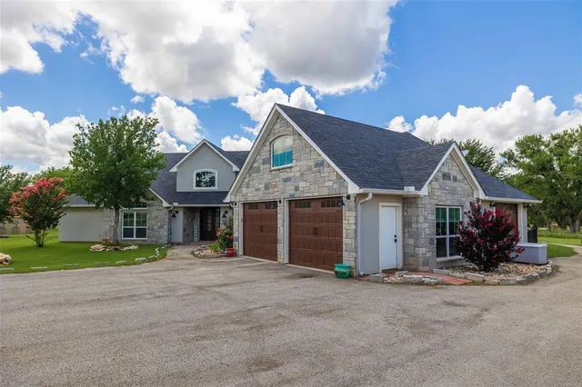 a view of a house next to a yard and road