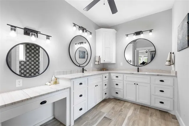 a bathroom with a double vanity sink and a mirror
