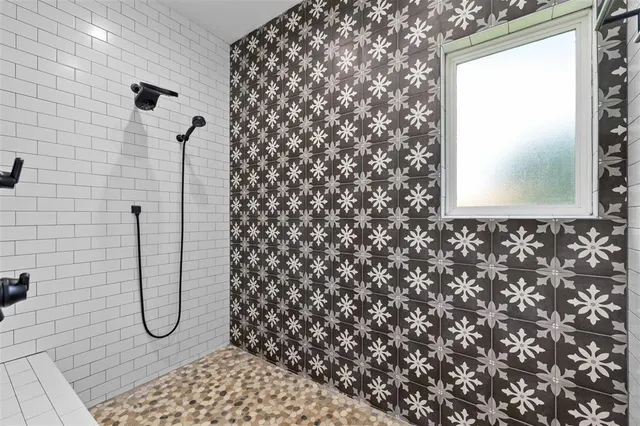 a bathroom with a granite countertop shower and a sink