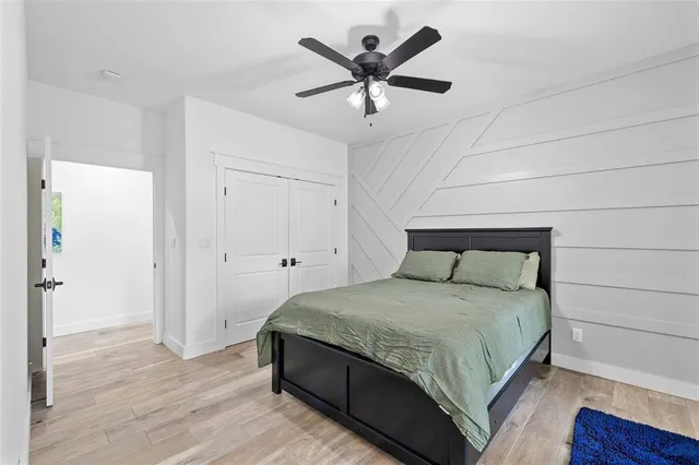 a bedroom with a bed and a ceiling fan