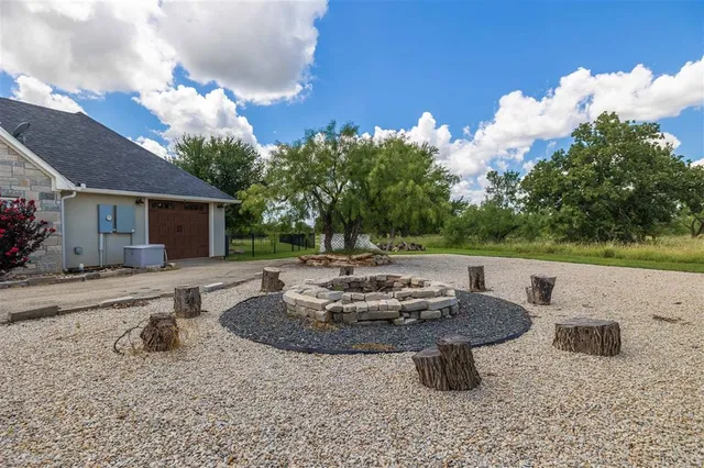 a view of a house with backyard and sitting area