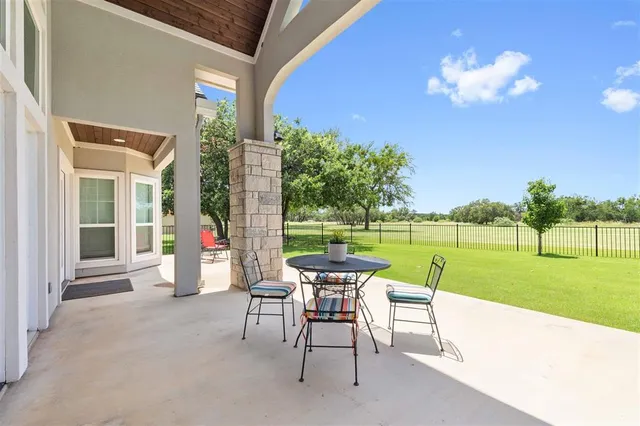 a view of a patio with a table & chairs