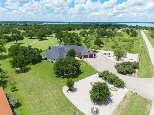 an aerial view of a house with a yard