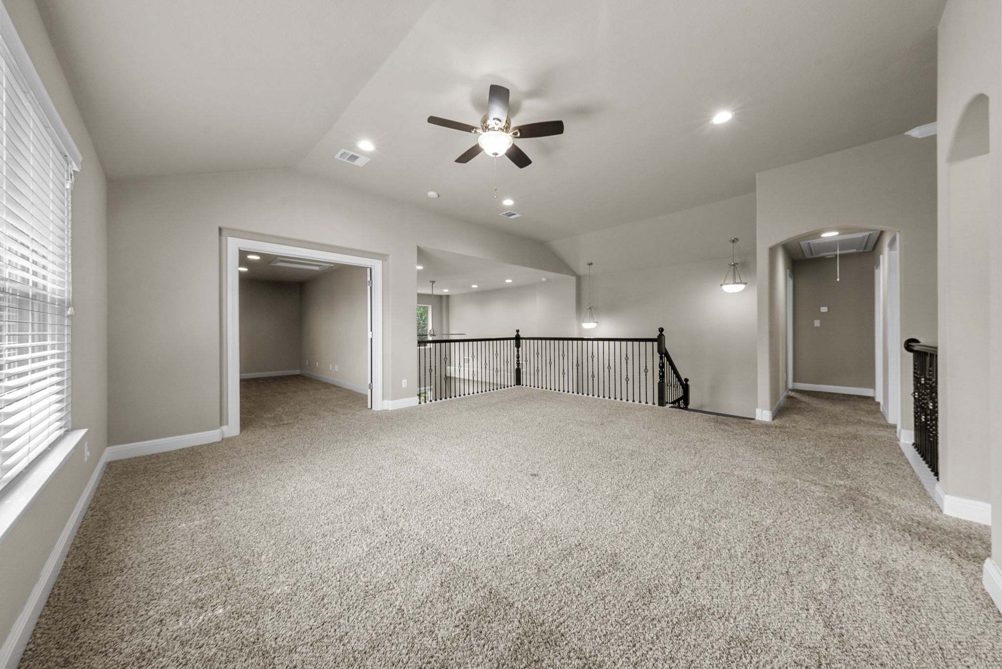4401 Trinity Woods Street Leander, TX 78641 - Photo 27 of 37 A spacious upper-level retreat offers comfortable carpeting, recessed lighting, and a ceiling fan for year-round comfort.