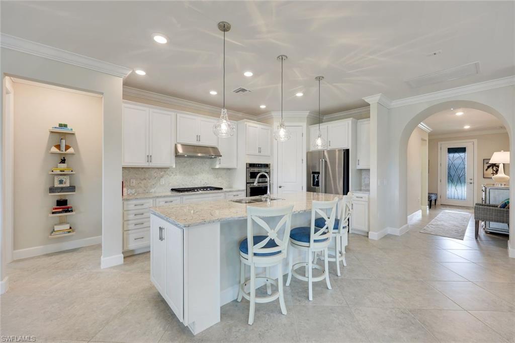 20052 Wymberly Way Estero, FL 33928 - Photo 1 of 27 a large kitchen with a table and chairs
