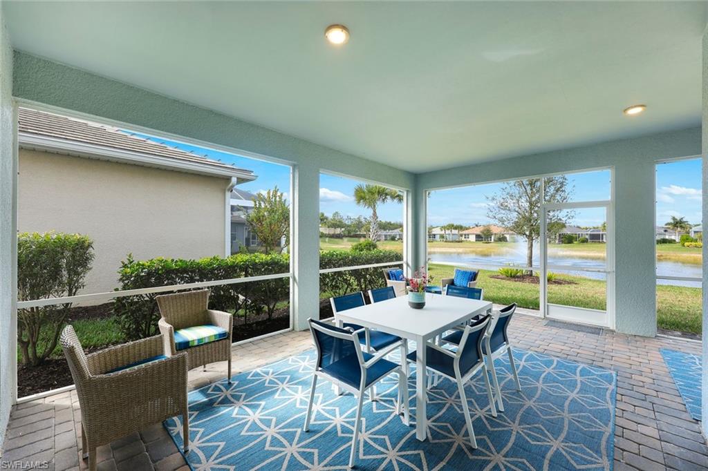 20052 Wymberly Way Estero, FL 33928 - Photo 18 of 27 a view of a patio with a dining table and chairs