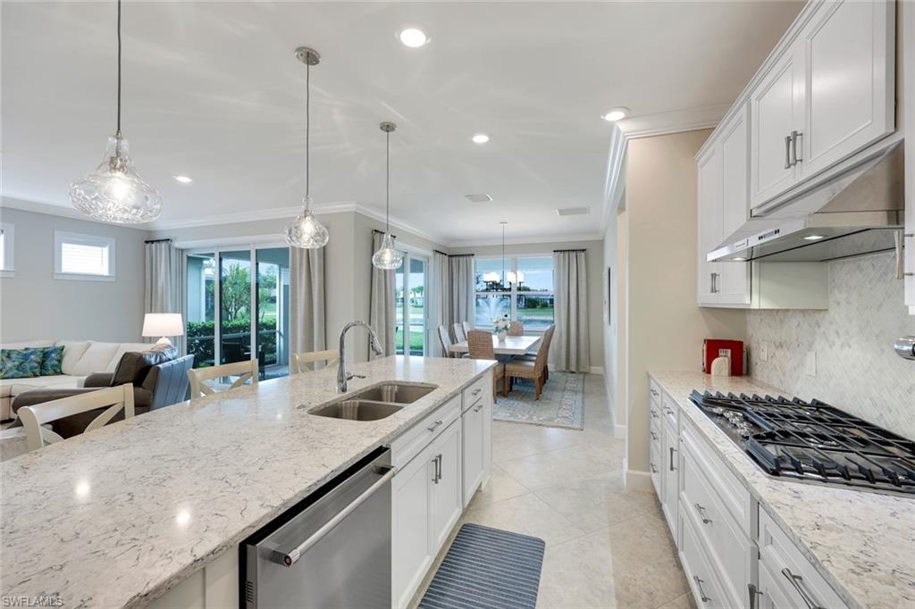 20052 Wymberly Way Estero, FL 33928 - Photo 3 of 27 a kitchen with sink stove and cabinets