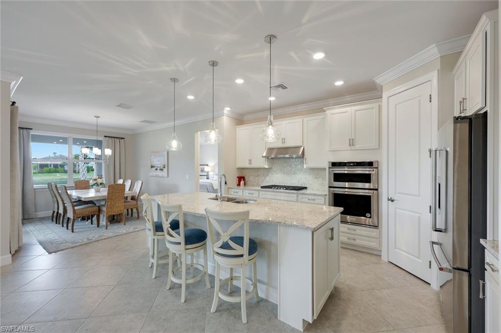 20052 Wymberly Way Estero, FL 33928 - Photo 4 of 27 a kitchen with a sink and chairs