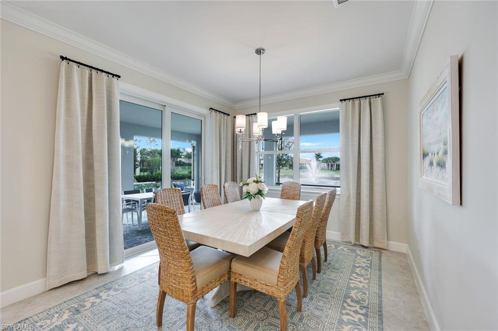 20052 Wymberly Way Estero, FL 33928 - Photo 5 of 27 a dining room with furniture a chandelier and window