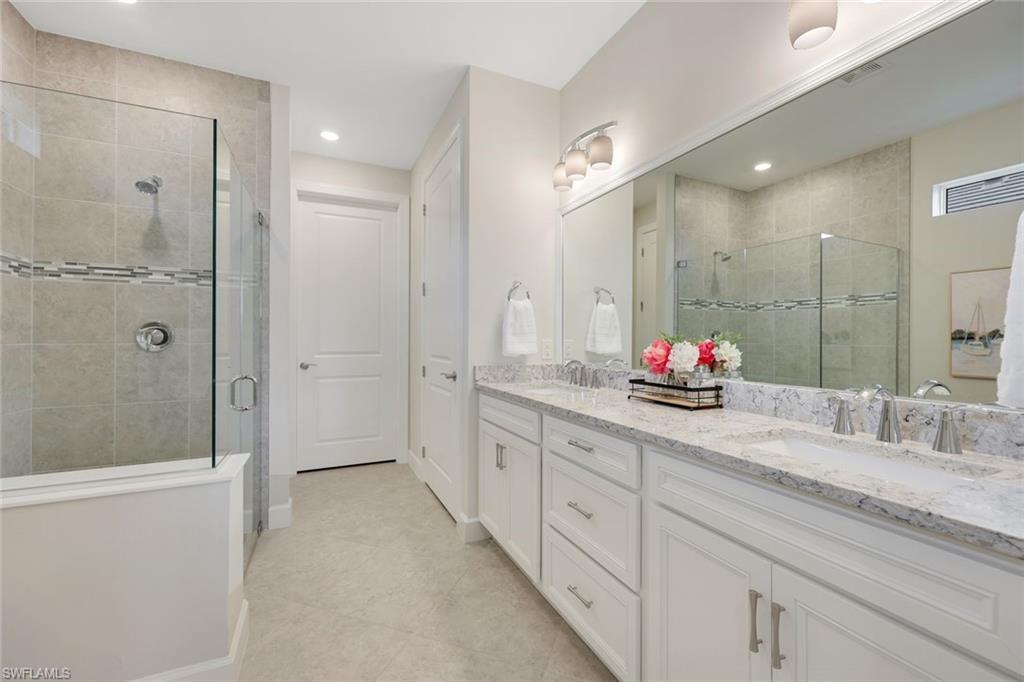 20052 Wymberly Way Estero, FL 33928 - Photo 8 of 27 a bathroom with a granite countertop sink mirror and shower