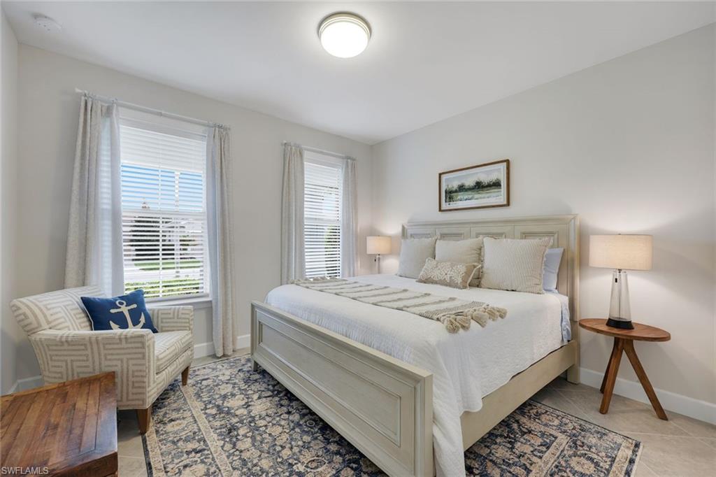 20052 Wymberly Way Estero, FL 33928 - Photo 9 of 27 a bedroom with a bed and a couch