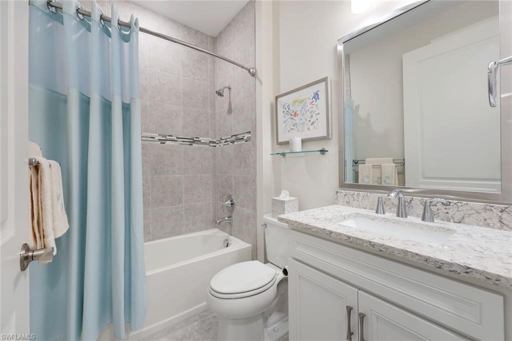 20052 Wymberly Way Estero, FL 33928 - Photo 10 of 27 a bathroom with a granite countertop sink toilet and shower
