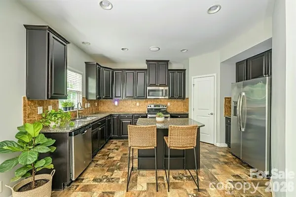 a kitchen with a sink and refrigerator