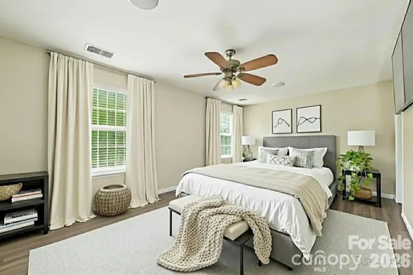 a bedroom with a bed and a large window
