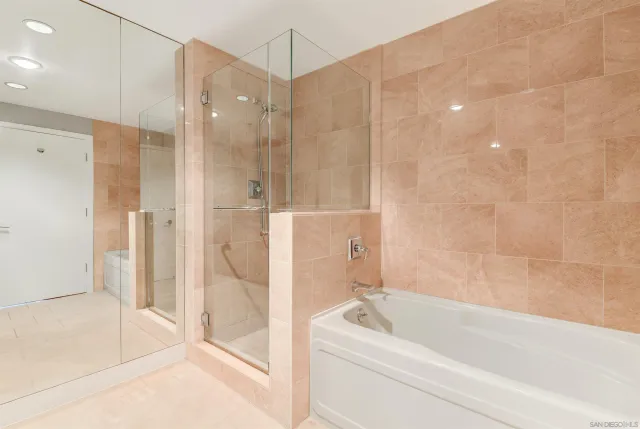 a bathroom with a bathtub and a shower