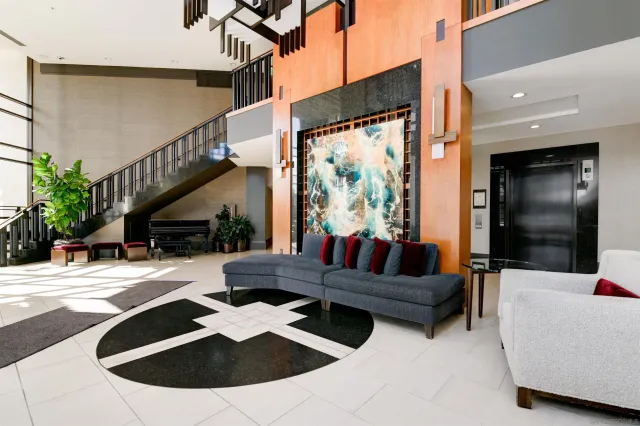 a living room with furniture and a potted plant
