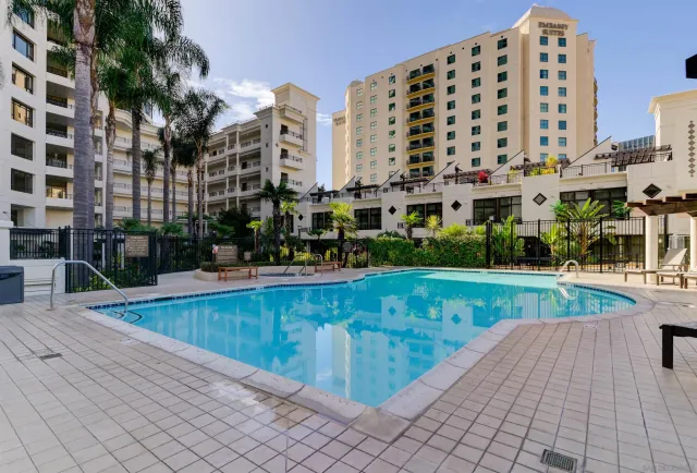 a view of swimming pool with outdoor seating and plants