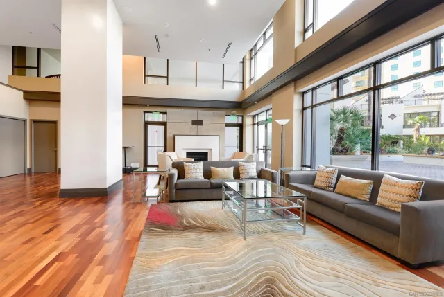 a living room with furniture wooden floor and a large window