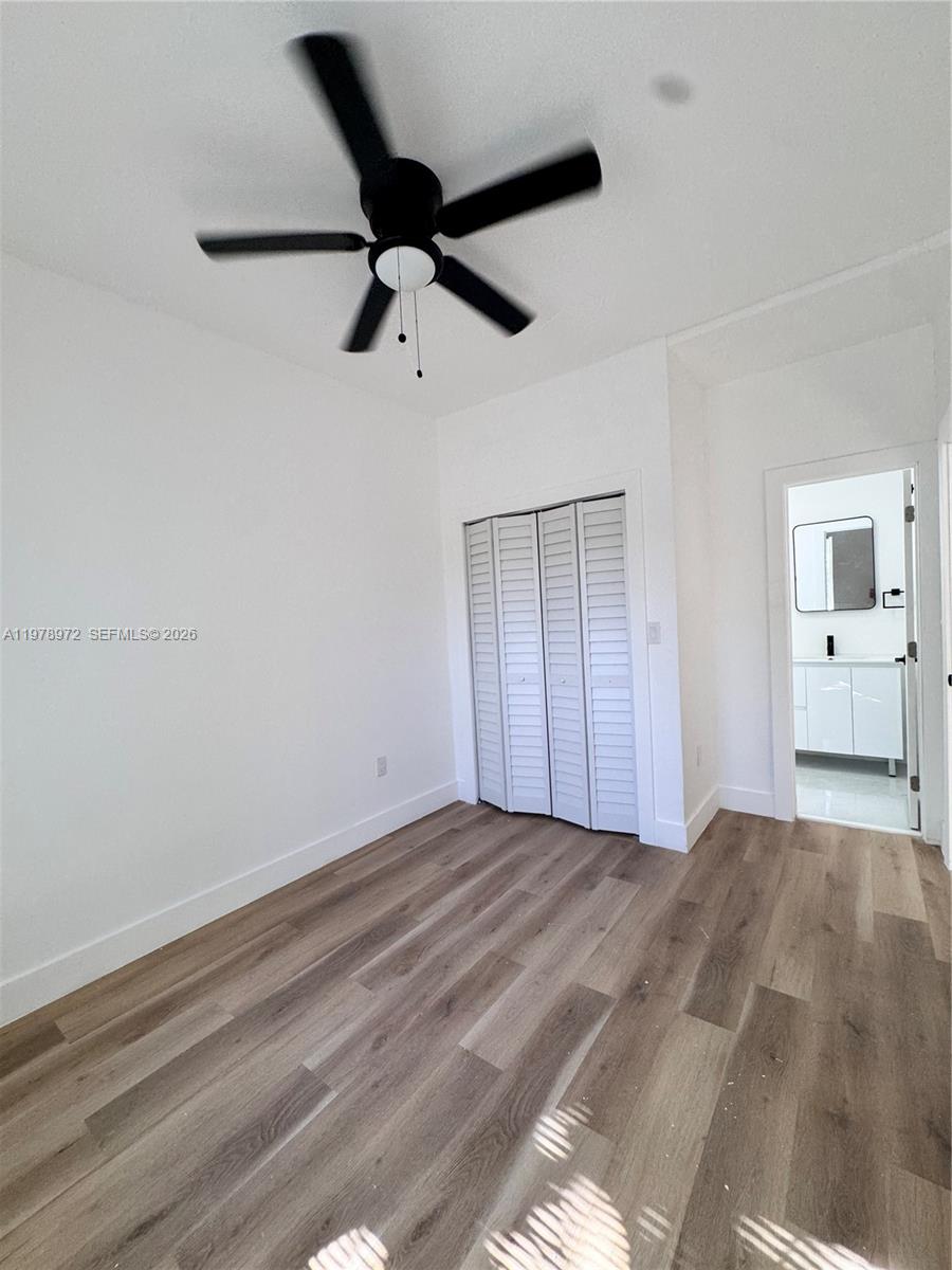 4028 Southwest 11th Street Miami, FL 33134 - Photo 14 of 17 a view of empty room with wooden floor and window