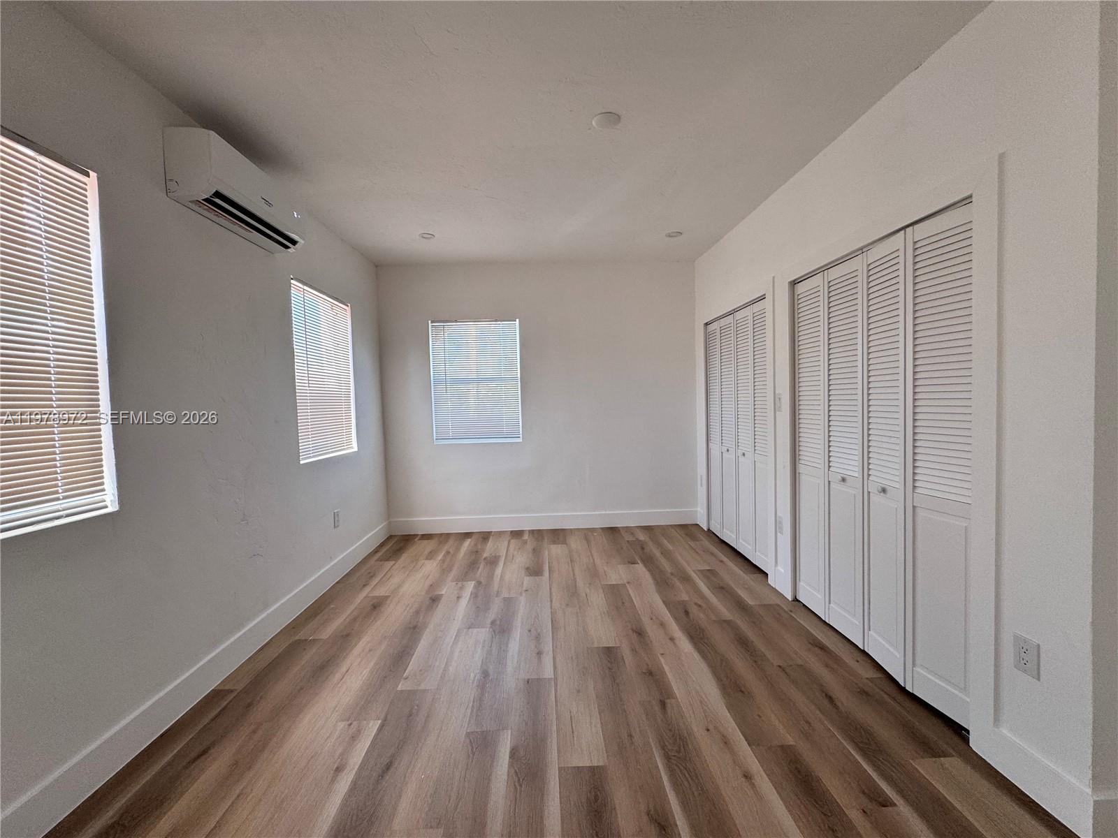 4028 Southwest 11th Street Miami, FL 33134 - Photo 15 of 17 a view of an empty room with wooden floor and a window