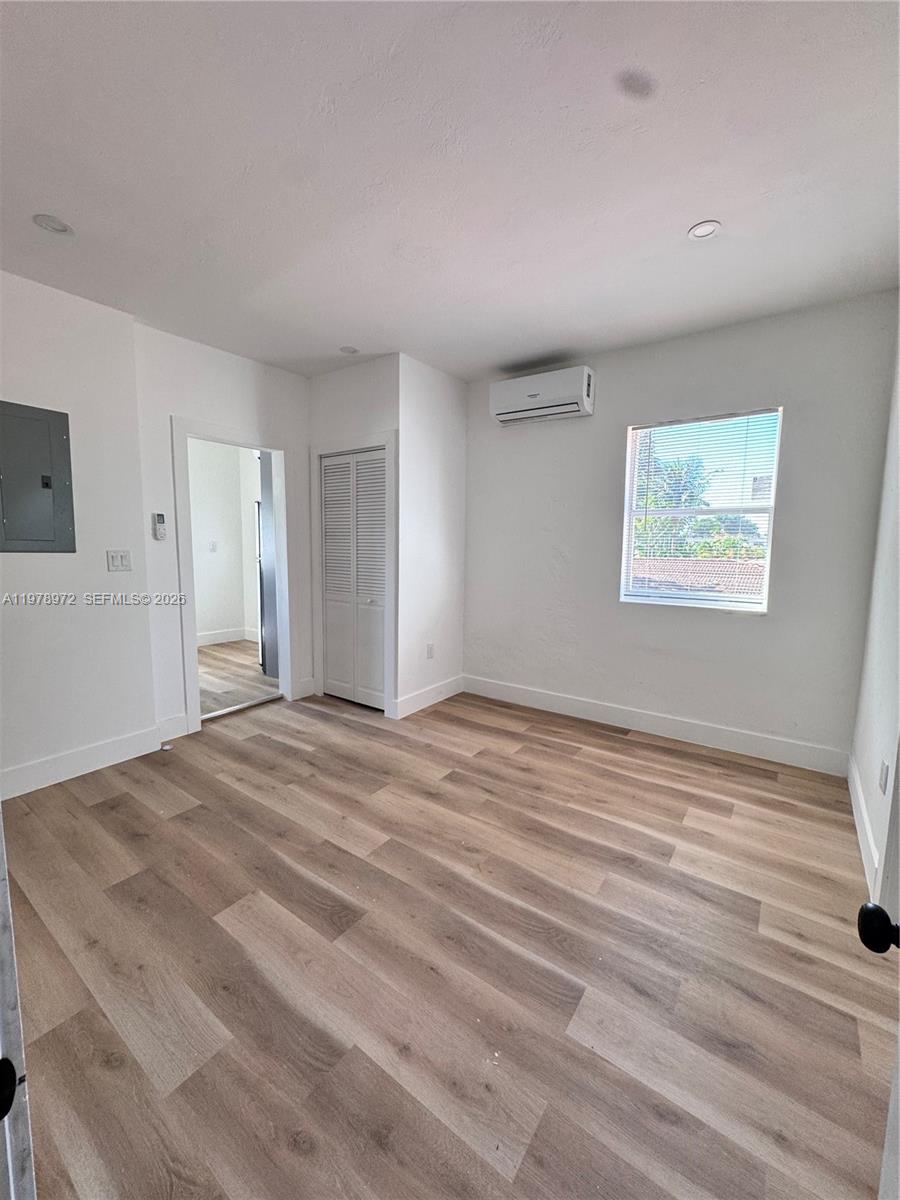 4028 Southwest 11th Street Miami, FL 33134 - Photo 16 of 17 a view of empty room with wooden floor and fan