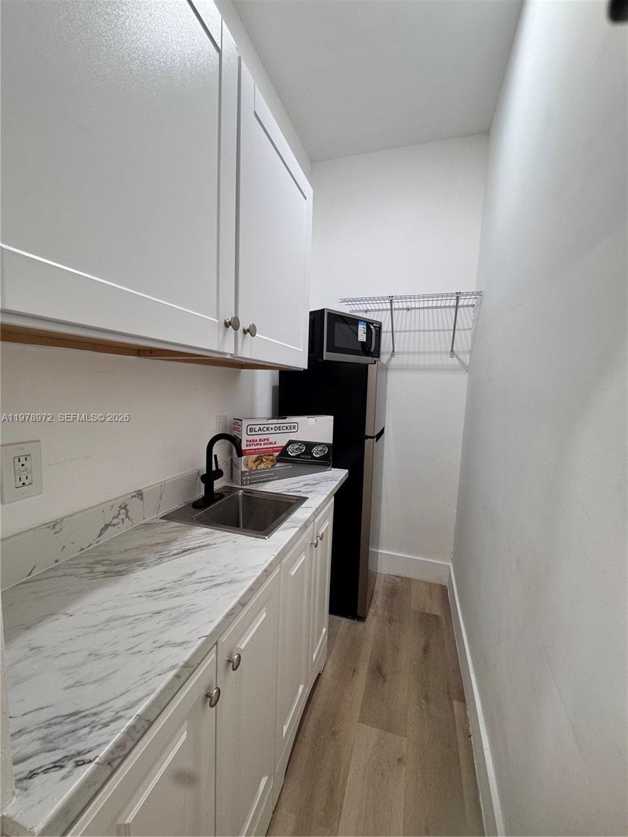 4028 Southwest 11th Street Miami, FL 33134 - Photo 7 of 17 a kitchen with a sink and a refrigerator