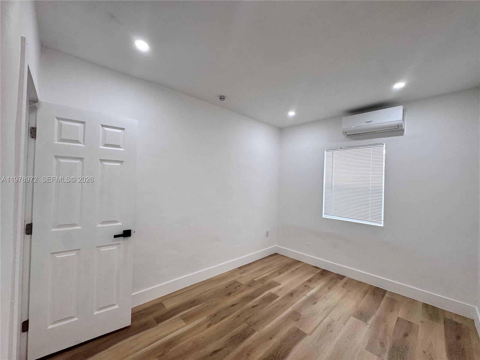 4028 Southwest 11th Street Miami, FL 33134 - Photo 9 of 17 an empty room with wooden floor and window