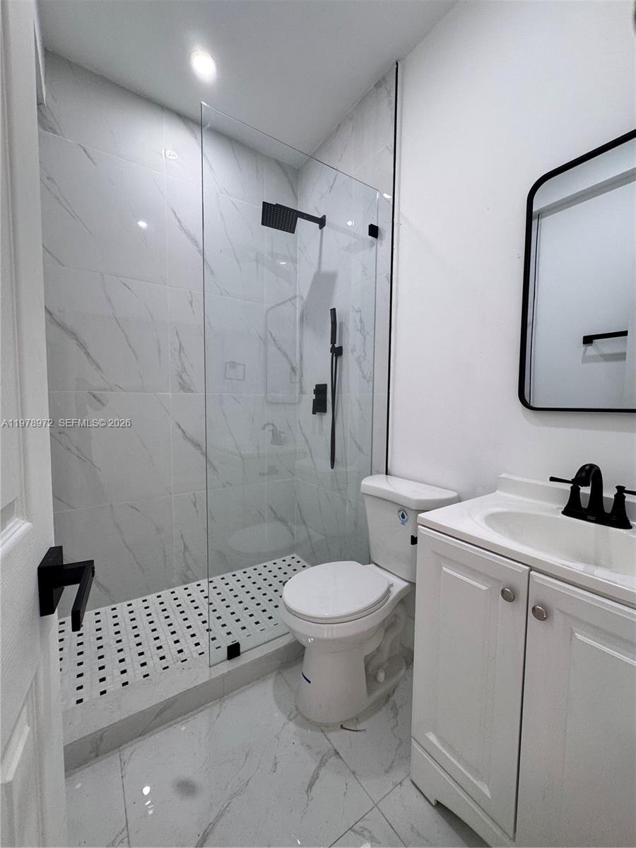 4028 Southwest 11th Street Miami, FL 33134 - Photo 10 of 17 a bathroom with a toilet sink and shower