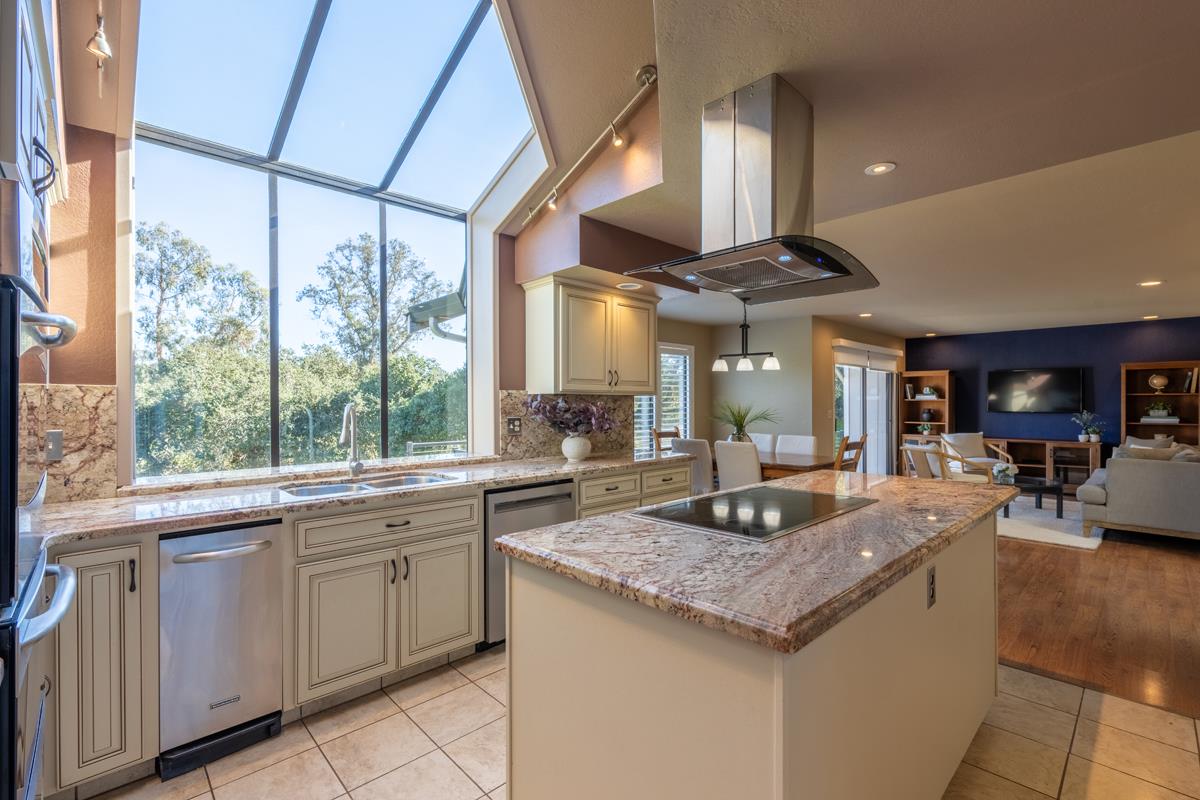 18795 Pesante Road Salinas, CA 93907 - Photo 11 of 20 a kitchen with granite countertop center island wooden floor and stainless steel appliances