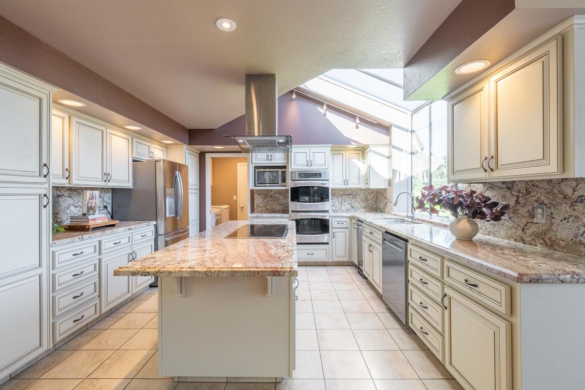 18795 Pesante Road Salinas, CA 93907 - Photo 4 of 20 a large kitchen with kitchen island granite countertop lots of counter space and windows