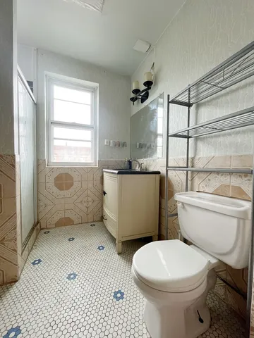 a bathroom with a toilet a sink and a shower