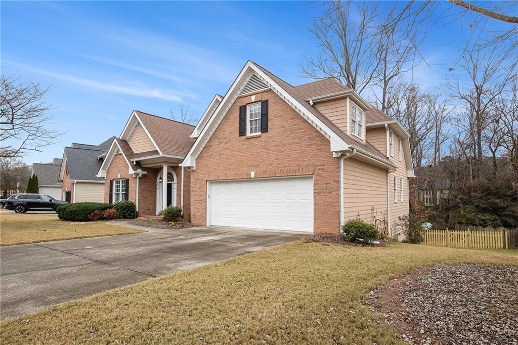 1389 Turtlebrook Lane Lawrenceville, GA 30043 - Photo 2 of 30 a front view of a house with a yard and garage