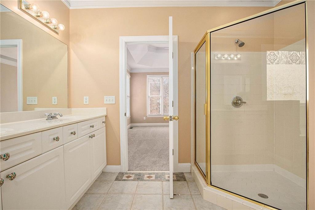 1389 Turtlebrook Lane Lawrenceville, GA 30043 - Photo 21 of 30 a bathroom with a shower sink and mirror