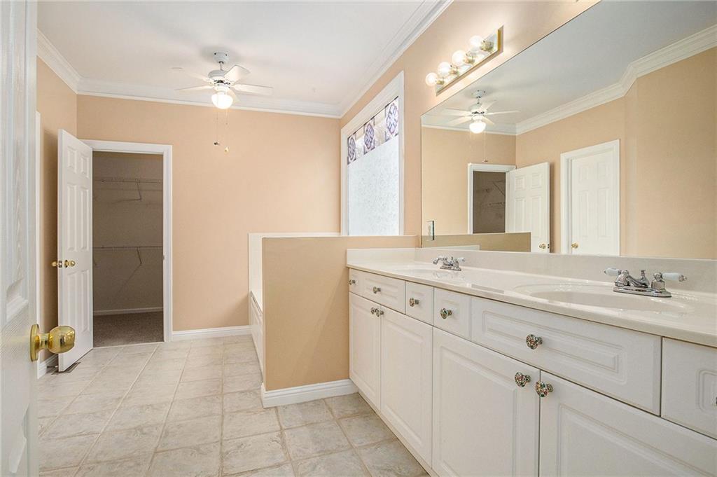 1389 Turtlebrook Lane Lawrenceville, GA 30043 - Photo 24 of 30 a spacious bathroom with a double vanity sink mirror and