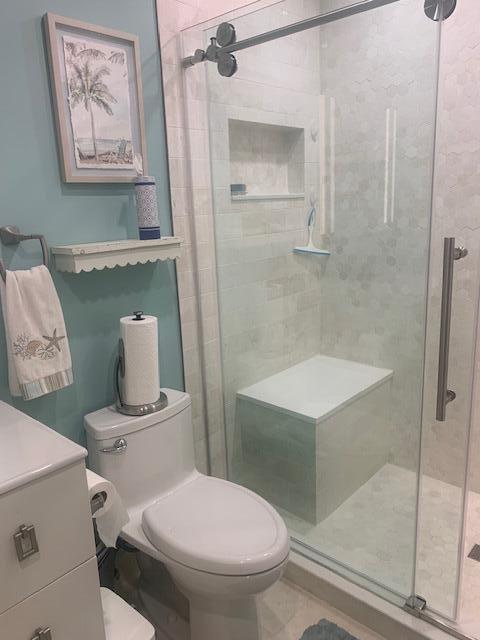 123 Lake Gloria Drive West Palm Beach, FL 33411 - Photo 16 of 25 a white toilet sitting next to a bathroom sink