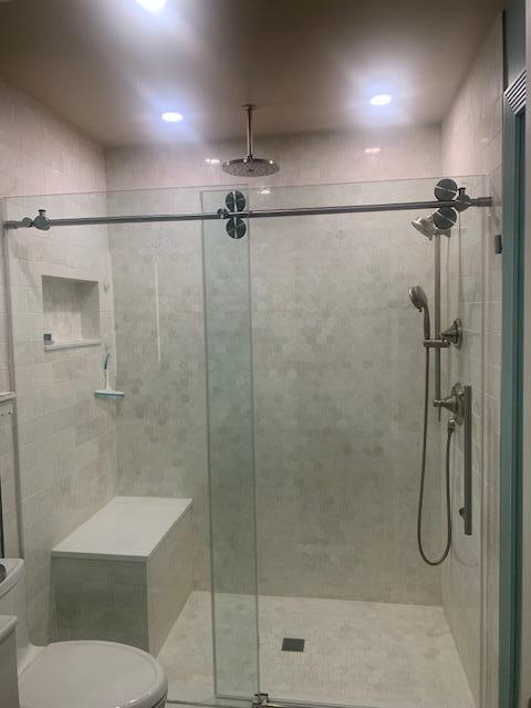 123 Lake Gloria Drive West Palm Beach, FL 33411 - Photo 17 of 25 a bathroom with a shower a toilet and a sink