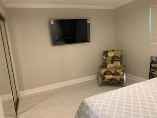 123 Lake Gloria Drive West Palm Beach, FL 33411 - Photo 18 of 25 a bedroom with a bed and a flat screen tv