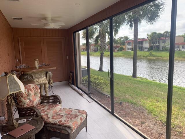123 Lake Gloria Drive West Palm Beach, FL 33411 - Photo 3 of 25 a living room with a floor to ceiling window and a table