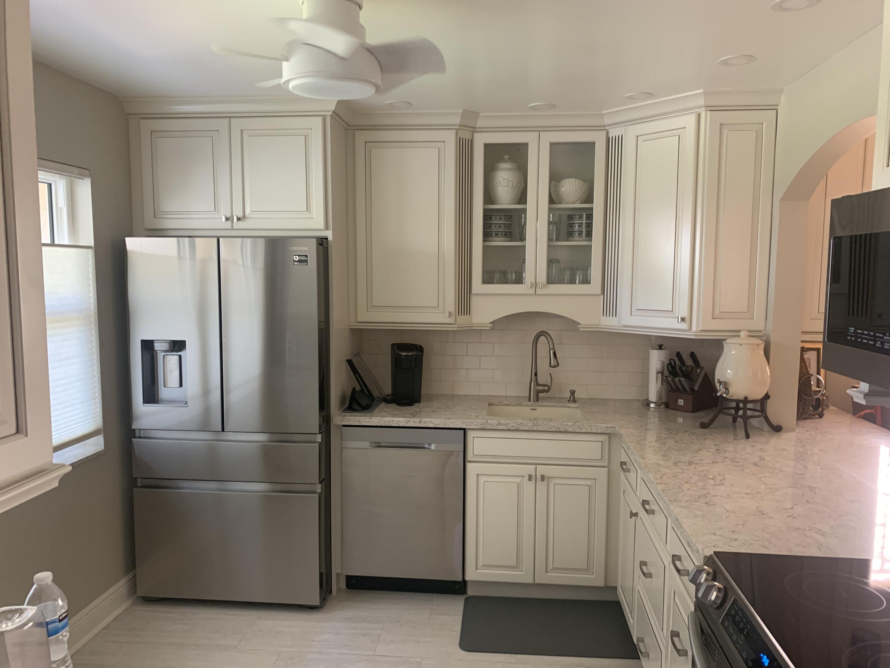 123 Lake Gloria Drive West Palm Beach, FL 33411 - Photo 6 of 25 a kitchen with white cabinets and refrigerator