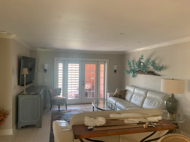 a bedroom with furniture and a large window