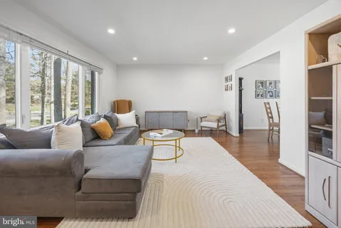 a living room with furniture and large window