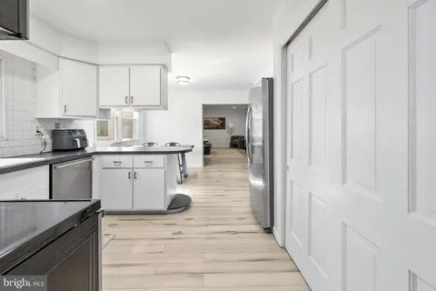 a kitchen with a sink cabinets and window