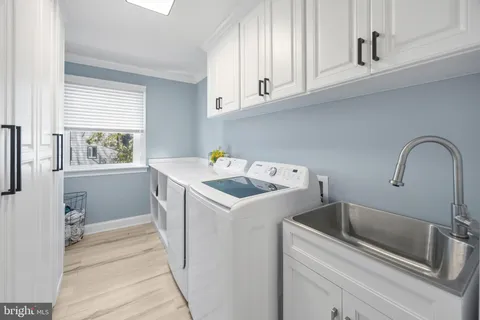 a utility room with sink dryer and washer