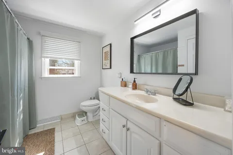 a spacious bathroom with a sink a toilet and shower